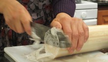 Slicing young banana trunks for salad.