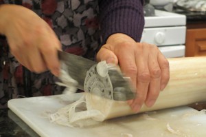 Slicing young banana trunks for salad.