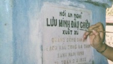A relative painting the carved in letters of Grandfather's first grave.