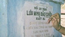 A relative painting the carved in letters of Grandfather's first grave.