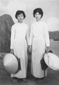 Chị Ba (Lan) and Chị Hai (Thanh) wearing school clothes--a white traditional long dress with pants (áo dài). 